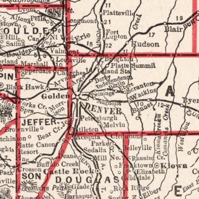 A framed vintage map displayed in a warm and thoughtfully designed interior
