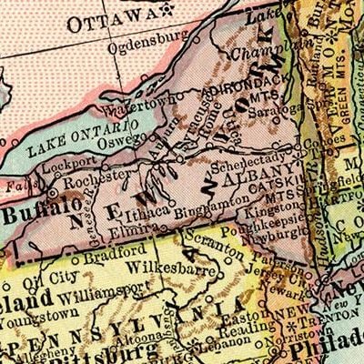 A framed vintage map displayed in a warm and thoughtfully designed interior